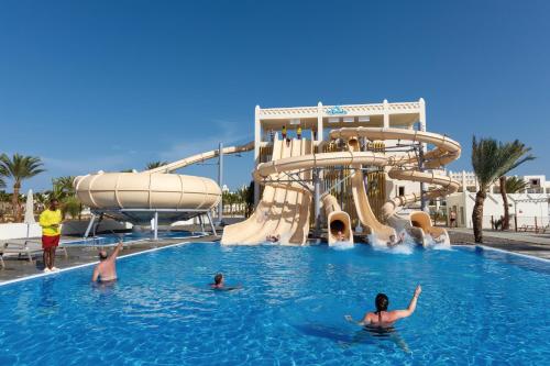 a group of people in a swimming pool at a water park at Hotel Riu Palace Boavista - All Inclusive in Boa Ventura