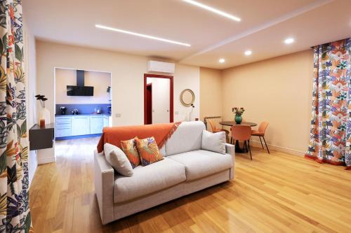 a living room with a couch and a table at All'Angolo Deluxe Apartment in Alba