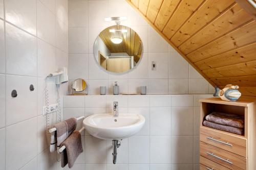 a bathroom with a sink and a mirror at Grundhof in Oberprechtal