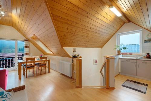 a kitchen and dining room with a wooden ceiling at Grundhof in Oberprechtal