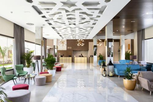 a lobby with couches and chairs in a building at Hotel Riu Palace Boavista - All Inclusive in Boa Ventura
