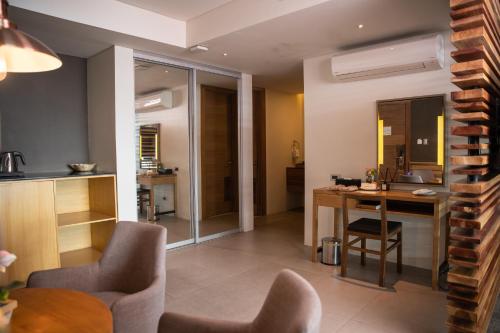 a kitchen and living room with a table and chairs at Escala Tagaytay in Tagaytay