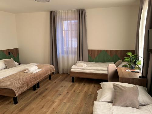 a room with two beds and a window at Penzion Aurelia Donovaly in Donovaly