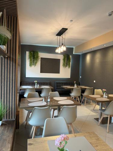 a restaurant with tables and chairs and a screen at Skyline Hotel Hannover in Hannover