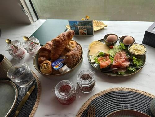 a table with two plates of food on it at Bed&Bus met dakterras in Rucphen
