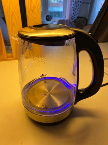 a black and yellow coffee pot sitting on a table at Central cozy accommodation, single room or bed in dormroom in Gothenburg