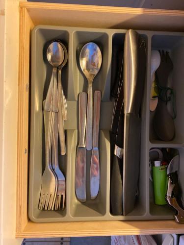a drawer filled with spoons and forks and knives at Central cozy accommodation, single room or bed in dormroom in Gothenburg