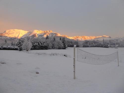 a volleyball net in the snow with a mountain at Ferme de la grande Moucherolle in Villard-de-Lans