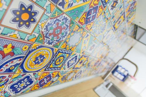 a tiled wall with colorful tiles on it at Villa Donna Antonia - Amalfi Coast in Conca dei Marini