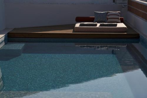 a bed sitting on top of a swimming pool at Andronis Minois in Parasporos