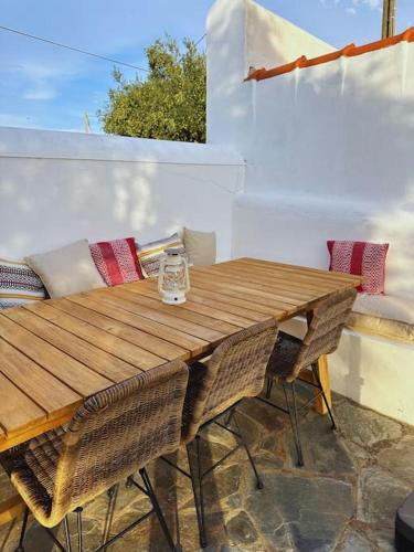 a wooden table and chairs on a patio at Monte de Santa Rita in Évora Monte