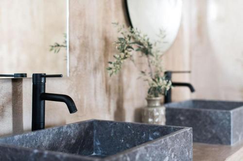 a sink with a faucet in a bathroom at Andronis Arcadia Hotel in Oia