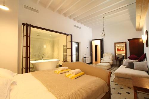 a bedroom with a bed and a tub and a sink at Mallorca One in Pollença