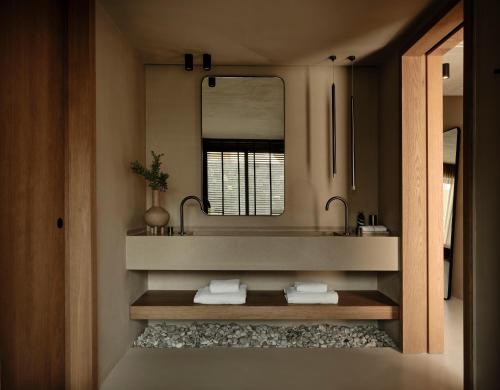 a bathroom with a sink and a mirror at Andronis Arcadia Hotel in Oia