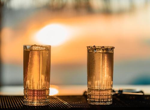 two glasses of water sitting on a table at Andronis Arcadia Hotel in Oia