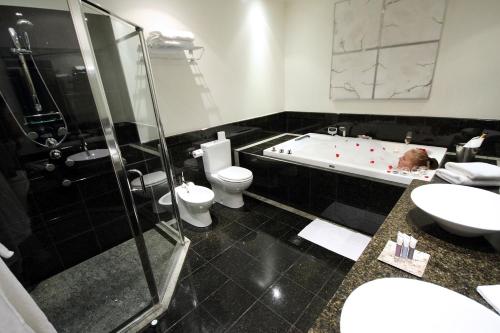 a child laying in a bath tub in a bathroom at Braemar Lodge And Spa in Hanmer Springs