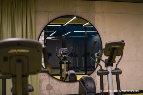 a mirror in a room with some exercise equipment at Hotel Indigo Vienna - Naschmarkt by IHG in Vienna