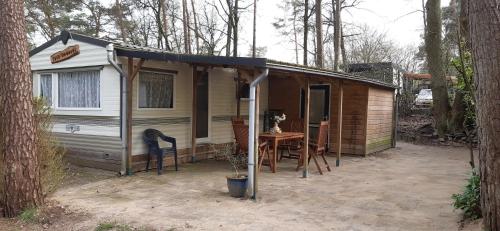 a small house with a table and a tent at Casa Emanuèl in IJhorst
