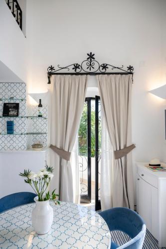 a dining room with a table and a window at Casetta Arienzo in Positano
