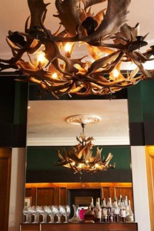 a chandelier hanging over a bar in a restaurant at Middle Park Hotel in Melbourne