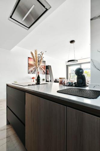 a kitchen with a large island with a counter top at Sunrise new apartment with pool in Alicante
