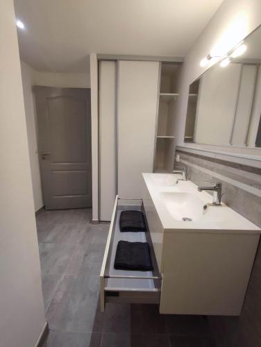 a white bathroom with two sinks and a counter at Appartement 64m2 in Ambérieu-en-Bugey