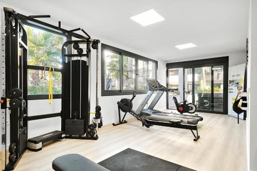 a gym with a treadmill and a tread machine at Sunrise new apartment with pool in Alicante