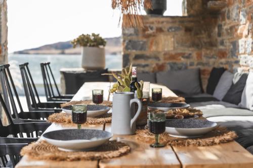 a wooden table with plates of food on it at Harmony Luxury Villas Naxos in Naxos Chora