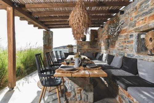 an outdoor dining room with a table and chairs at Harmony Luxury Villas Naxos in Naxos Chora
