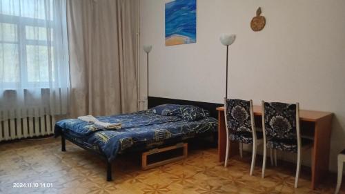 a room with a bed and a table and chairs at Alabama in Kyiv