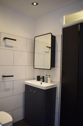 a bathroom with a sink and a mirror at The Little Luxury Getaway! in Moortown