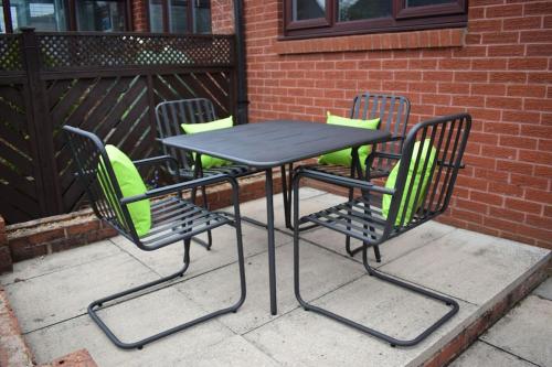 a picnic table and chairs on a patio at The Little Luxury Getaway! in Moortown