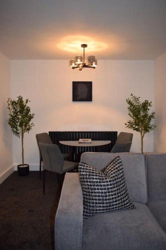 a living room with a couch and a table at The Little Luxury Getaway! in Moortown