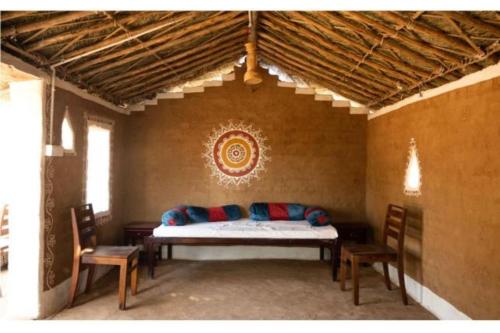 a room with a couch and chairs in a room at The Ker desert camp in Jaisalmer