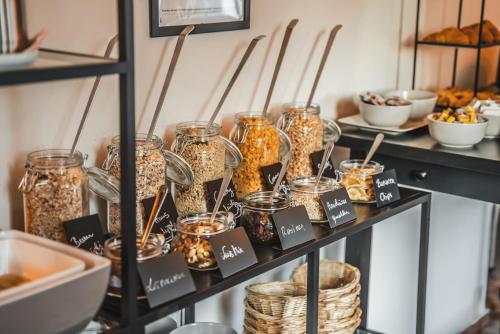 a shelf with jars filled with food on it at Boutiquehotel Caravella Velden by S4Y in Velden am Wörthersee