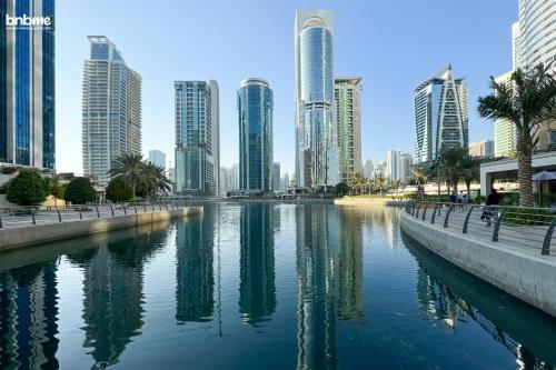 a river in a city with tall buildings at bnbmehomes - Gold crest views 2 in Dubai