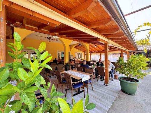 an outdoor patio with a table and chairs at Apartments Neptun in Šilo