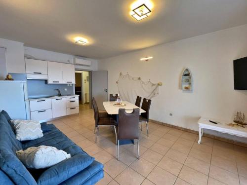 a living room with a blue couch and a table at Apartments Neptun in Šilo