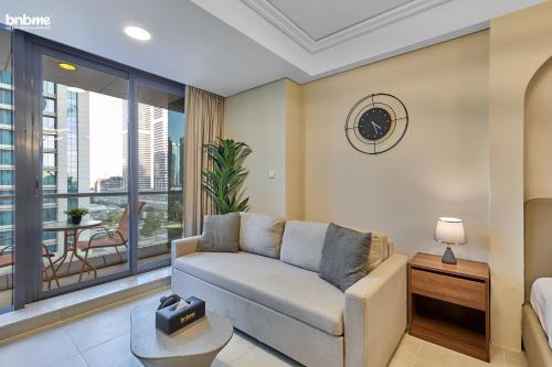 a living room with a couch and a large window at bnbmehomes - Gold crest views 2 in Dubai
