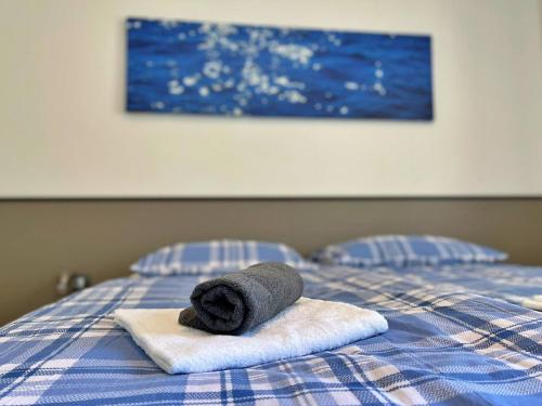 a towel sitting on top of a bed at Apartments Neptun in Šilo