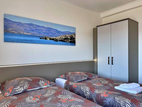 a bedroom with two beds and a cabinet at Apartments Neptun in Šilo