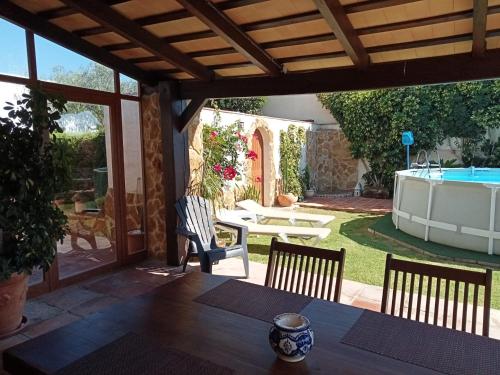 a patio with a table and chairs and a pool at Livingtarifa Casa Ariza in Tarifa