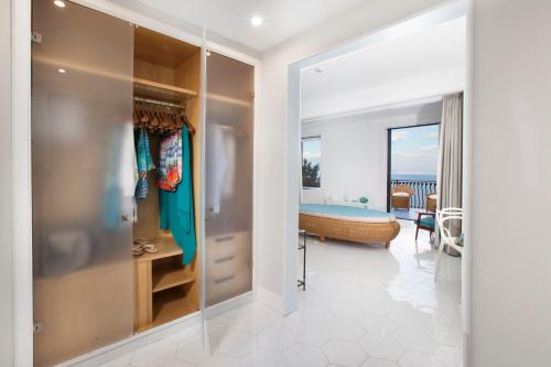 a room with a walk in closet and a bedroom at Hotel Belair in Sorrento