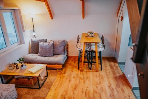 a living room with a table and a couch at Mon Cherry Vendégház in Esztergom