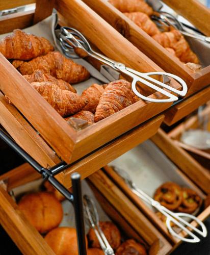 a bunch of different types of breads and pastries at Hotel International & Terminus in Geneva