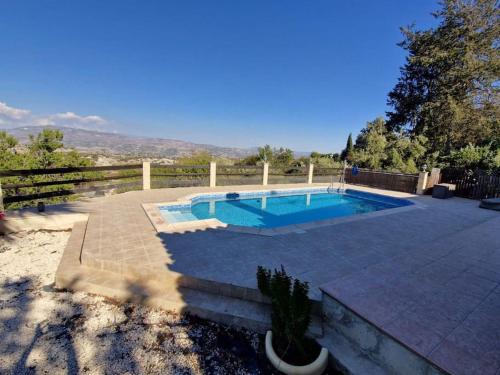 a swimming pool in a yard with a fence at Villa in Kallepia-Luxurious stay in Paphos City