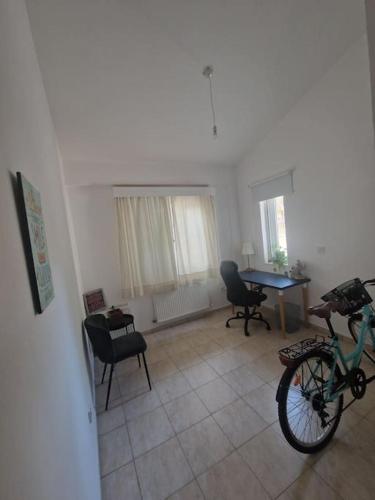 a living room with a bike and a table at Villa in Kallepia-Luxurious stay in Paphos City