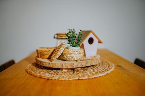 a table with a bird house and baskets on it at Mon Cherry Vendégház in Esztergom