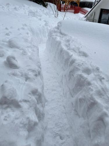 a pile of snow on the side of a road at Penzion Aurelia Donovaly in Donovaly