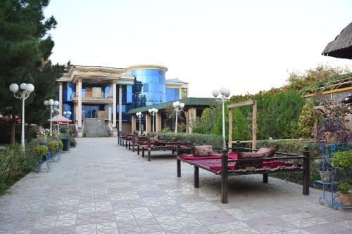 a row of benches in front of a building at Kefayat Hotel in Balkh